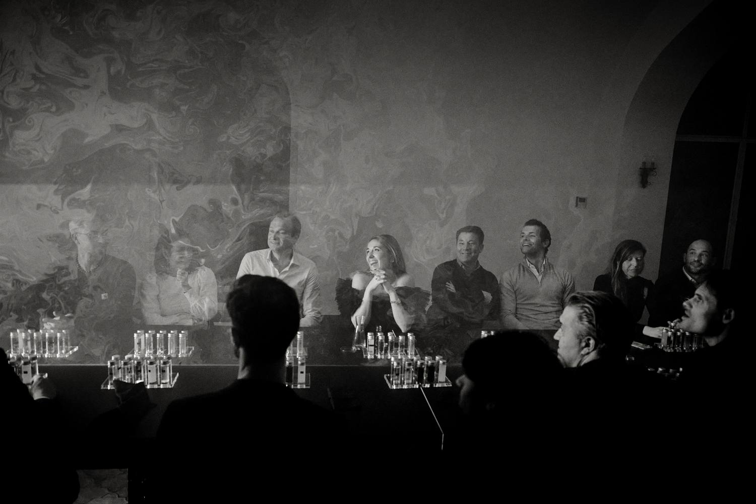 Guests laughing together along the length of the table during the Tabula Rasa dinner